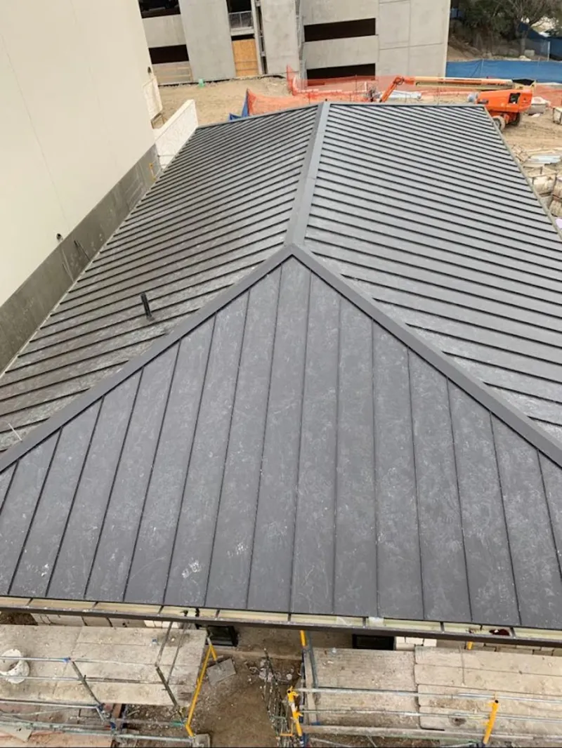 Commercial metal roof construction with crane equipment in Leicester